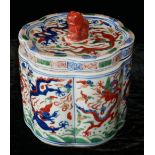 A CHINESE WUCAI PORCELAIN LOBE FORM BRUSH POT AND COVER Having a temple dog finial and flaming