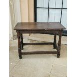 A 17TH CENTURY SIDE TABLE Having a planked oak moulded top, on turned legs and stretchers,