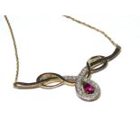 A VINTAGE 9CT GOLD, RUBY AND WHITE SAPPHIRE NECKLACE Having a pear cut ruby edged with white
