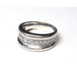 AN 18CT WHITE GOLD AND DIAMOND BAND RING The arrangement of graduating stones in a run over