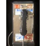 A VINTAGE AMERICAN WALL HANGING PAY PHONE. (53cm x 20cm x 17cm)