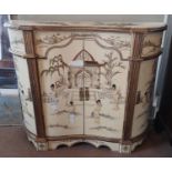 A 20TH CENTURY SIDE CABINET With japanned decoration on a cream ground, the inverted bow front