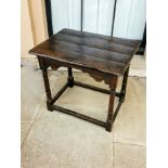 AN EARLY 18TH CENTURY OAK AND ELM SIDE TABLE Having a planked top, supported by a moulder frieze and
