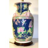 A 20TH CENTURY CHINESE PORCELAIN LAMP Famille rose pallet on a blue ground with Salamanca handles,