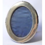 A VICTORIAN SILVER OVAL PHOTOGRAPH FRAME Plain form with easel frame, hallmarked William Comyns,
