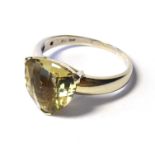 A VINTAGE YELLOW METAL AND CIRINE RING Having a faceted trillion cut stone (size S/T). (approx total