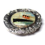 A STERLING SILVER AND ENAMEL OCEAN LINER PILL BOX The scroll case set with oval enamel panel
