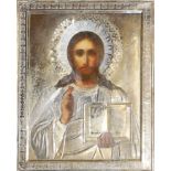 A MID 19TH CENTURY RUSSIAN ICON, CHRIST PANTOCRATOR, OIL ON PANEL Encased in a repousse and chased