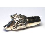 A STERLING SILVER NOVELTY BOAR'S HEAD FORM WHISTLE Embossed decoration and glass eyes. (approx 4cm)