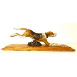A COLD PAINTED BRONZE LETTER CLIP IN THE FORM OF A DOG Running pose with central hinge to body and