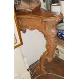 A 19TH CENTURY WALNUT CONSOLE TABLE OF NARROW PROPORTIONS With heavily carved apron, raised on an