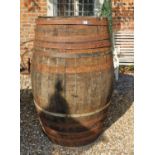 A LARGE EARLY 20TH CENTURY IRON BOUND COOPERED BARREL. (80cm x 126cm)