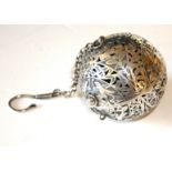 AN UNUSUAL ORIENTAL WHITE METAL SPHERICAL HAND WARMER Pierced design with exotic birds, the interior