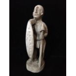 AN EARLY 20TH CENTURY TRIBAL WOODEN CARVED FIGURE Standing pose with axe and shield. (approx 44cm)