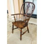 A GEORGIAN YEW AND ELM WOOD WINDSOR ARMCHAIR Having a hoop stick back and solid elm seat,