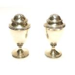A PAIR OF GEORGIAN SILVER BALUSTER PEPPERETTES With pierced dome and reeded border, hallmarked James
