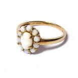 A VINTAGE 9CT GOLD AND OPAL CLUSTER RING The arrangement of cabochon cut stones forming a daisy