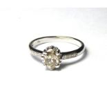 AN 18CT WHITE GOLD AND 0.86ct DIAMOND RING A single oval cut diamond with round cut diamonds to