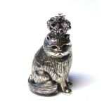 A STERLING SILVER NOVELTY MODEL OF A CAT WEARING A CROWN Having green glass eyes with red glass to