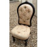 A VICTORIAN AESTHETIC PERIOD SPOON BACK NURSING CHAIR With carved ebonised frame with button
