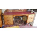 A MID 20TH CENTURY WALNUT WRITING DESK With red faux leather surface above and arrangement of six