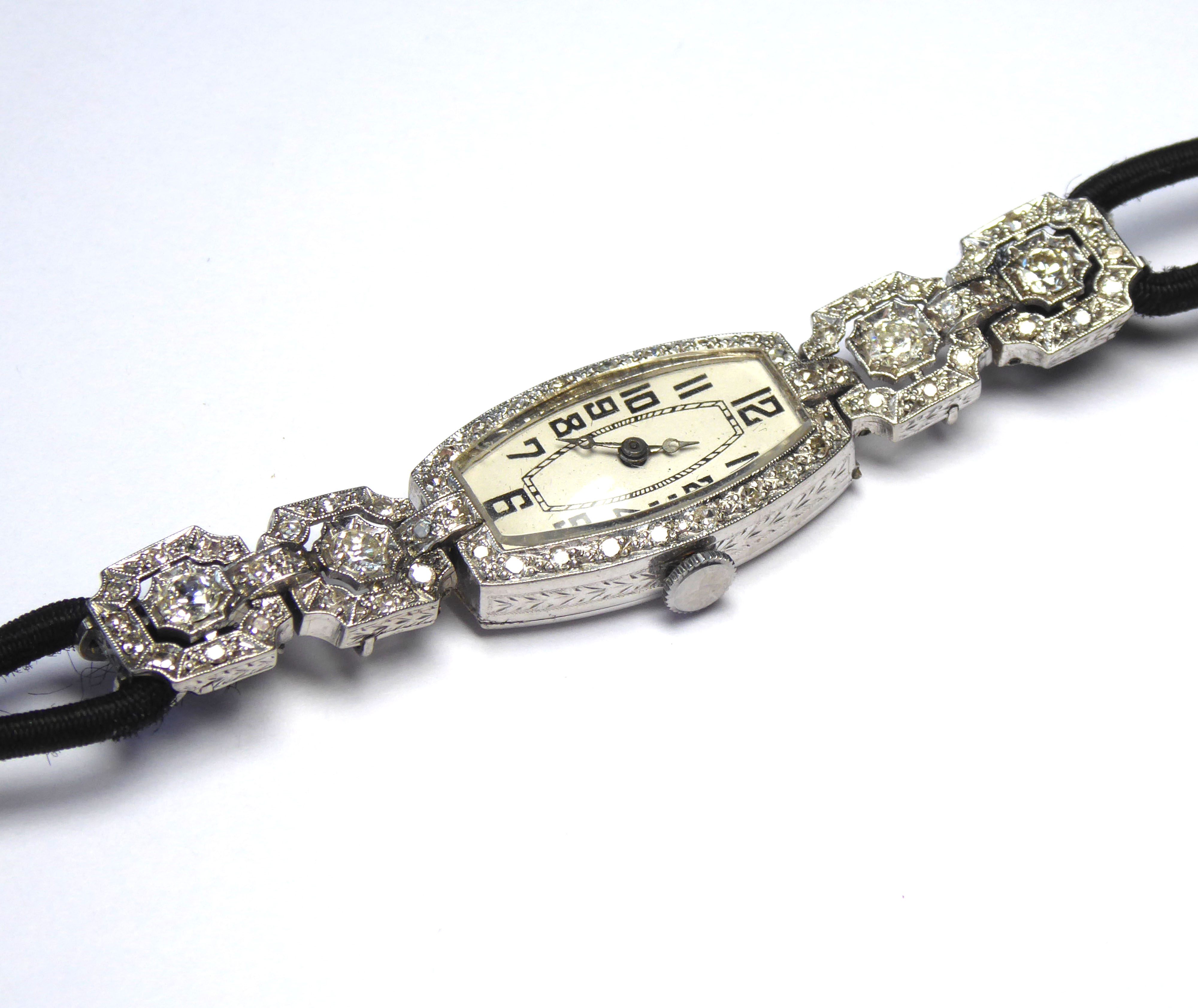 AN ART DECO, PLATINUM AND DIAMOND LADIES' COCKTAIL WATCH Lozenge dial, Arabic number markings,