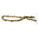 A VINTAGE 14CT GOLD, EMERALD AND DIAMOND BRACELET The oval emeralds interspersed with diamonds. (