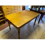 A WAXED PINE PLANK TOP DINING TABLE Having a single drawer, raised on ring turned legs. (w 77cm x