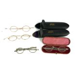 TWO PAIRS OF GEORGIAN SILVER OVAL SPECTACLES With plain frames, together with two pairs of gilt wire