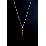 AN 18CT WHITE GOLD, RUBY AND DIAMOND TRILOGY PENDANT NECKLACE Three graduating Princess cut rubies