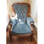 A VICTORIAN MAHOGANY FRAMED SPOONBACK ARMCHAIR Blue velvet button back upholstery, with scroll