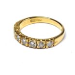 AN 18CT GOLD AND DIAMOND HALF ETERNITY RING The ingle row of seven round cut diamonds (size O).