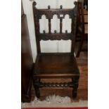 A 17TH CENTURY WALNUT RESTORATION CHAIR With carved and pierced cartouche above caned back and seat,