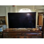 A PANASONIC 66' CURVE SCREEN TELEVISION With remote control.