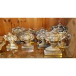 A COLLECTION OF NINE WHITE METAL CLASSICAL FORM MANTEL ORNAMENTS Cast as twin handled urns on carved