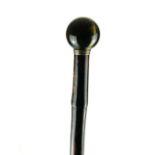 AN EARLY 20TH CENTURY TIGER'S EYE AND SILVER WALKING STICK Having a polished hardstone handle set