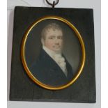 A 19TH CENTURY MINIATURE OVAL PORTRAIT OF A GENTLEMAN Wearing a black coat and white ruffle, gilt