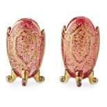 MOSER, A PAIR OF LATE 19TH/EARLY 20TH CENTURY RUBY GLASS AND GILT OVAL VASES With fine gilt