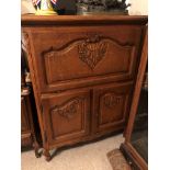 A 20TH CENTURY DUTCH OAK DRINKS CABINET With fall front above cupboards, on squat cabriole legs. (