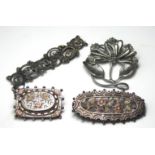 TWO EDWARDIAN SILVER AND ROSE GOLD PLATED SWEETHEART OVAL BROOCHES With pierced floral decoration