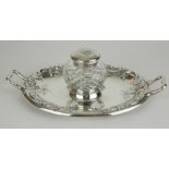 A VICTORIAN SILVER AND CUT LEAD CRYSTAL OVAL INKSTAND With twin handles, embossed floral