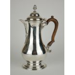 A GEORGIAN SILVER COFFEE POT Having an acorn form finial, carved wooden handle and engraved family