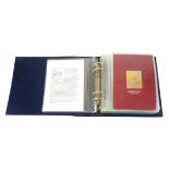 AN ALBUM OF THIRTY-FIVE 22CT GOLD LEAF ROYAL COMMEMORATIVE STAMPS Titled 'The Life and Times of