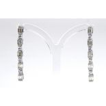 A PAIR OF 18CT WHITE GOLD AND DIAMOND DROP EARRINGS Line of baguette cut diamonds interspersed round