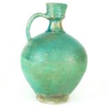 A LARGE 12TH CENTURY ISLAMIC POTTERY EWER Turquoise and lustre glazes. (30cm)