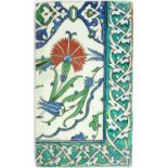 A FINE 16TH CENTURY IZNIK TILE, CIRCA 1575 Typically painted with stylised carnations and tulip