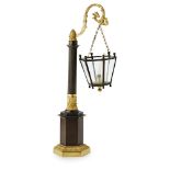 AN EARLY 19TH CENTURY FRENCH RESTORATION PATINATED AND GILT BRONZE CANDLE HOLDER Cast as a street