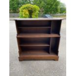 A 20TH CENTURY OAK OPEN WATERFALL BOOKCASE.