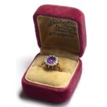 A 9CT GOLD AMETHYST AND PASTE RING The oval cut amethyst edged in paste stones. (size O/P)