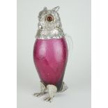 A SILVER PLATED CRANBERRY GLASS CLAREY JUG IN THE FORM OF AN OWL With clear glass handle. (h 29cm)